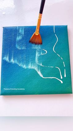 a brush is sitting on top of a painting