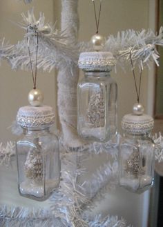 a white christmas tree decorated with snowflakes and mason jars