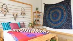 a room with a bed, rugs and shelves on the wall next to it