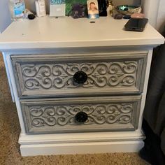 an old dresser has been painted with white paint