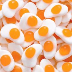 orange and white candies with eggs on them are shown in close up view from above