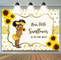 a sunflower is on the way sign in front of a brick wall with spotlights