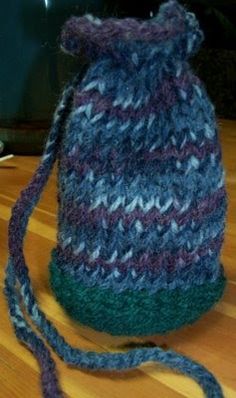 a knitted hat sitting on top of a wooden table