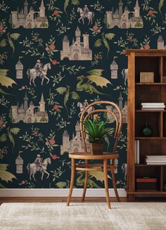 a chair sitting in front of a wallpaper with horses and castle designs on it