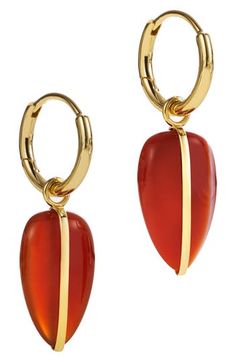 Hand-carved carnelian shape drop earrings glinting with 14-karat gold. 1 1/4" drop; 3/8" width Hinge with snap-post closure Carnelian/14k gold Imported Gold Carnelian Teardrop Jewelry, Carnelian Earrings Gold, Gold Carnelian Gemstone Earrings, Red Carnelian Pierced Earrings, Red Carnelian Teardrop Earrings, Drop Hoop Earrings, Fabric Gift Bags, Keep Jewelry, Fabric Gifts