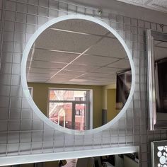 a mirror that is on the side of a wall