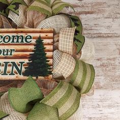 welcome to your cabin door hanger on a wreath with burlocks and pine trees