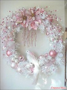 a pink perfume bottle next to an image of a wreath with flowers and pearls on it