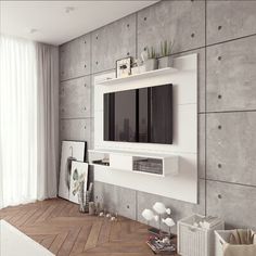 a modern living room with concrete walls and white furniture, including a flat screen tv mounted on the wall