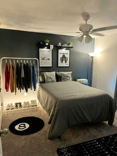 a bed room with a neatly made bed and pictures on the wall