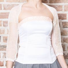 This loose knit white linen bolero is made of 100% linen yarn. Elegant way to keep your shoulders warm on chilly days and evenings on that special wedding day. This bolero also looks good with any type of gown for special occasions and date nights. It is possible to order a custom clothing in your size and color. Made from high quality Italian yarn. Hand wash only, dry flat. This is SuperSoftKnits original. More boleros: https://www.etsy.com/shop/supersoftknits?ref=hdr_shop_menu&section_id=1 Elegant White Fitted Cardigan, White Chic Fitted Shrug, Elegant Fitted Cardigan For Weddings, Elegant Cream Cardigan For Wedding, White Party Shrug For Spring, White Cardigan For Spring Wedding, Fitted Summer Wedding Shrug, Fitted Shrug For Summer Wedding, White Fitted Shrug For Evening