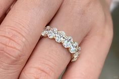 a woman's hand with a diamond ring on it