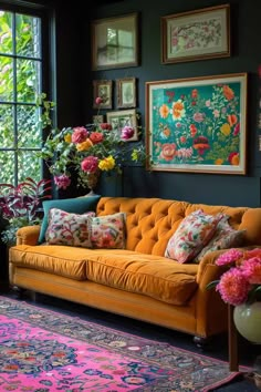 a living room with an orange couch and colorful rugs on the floor next to large windows