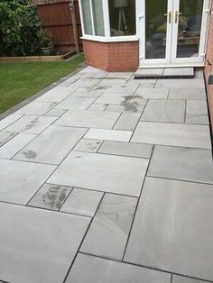 an outdoor patio with stone pavers and brick walls