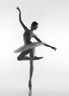 a ballerina in black and white poses for the camera