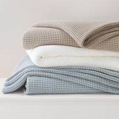 three blankets stacked on top of each other