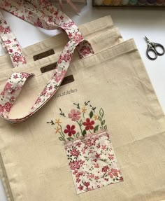 a bag with flowers on it next to some scissors