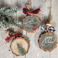 three christmas ornaments hanging from wood slices