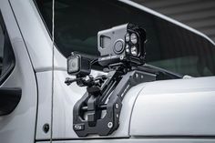 the front view of a white truck with a camera attached to it's handlebars