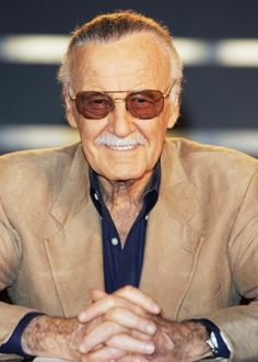 an older man wearing sunglasses and sitting at a table