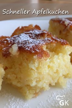 a close up of a piece of cake on a plate with powdered sugar over it