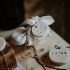 some white tags are tied up on a wooden table