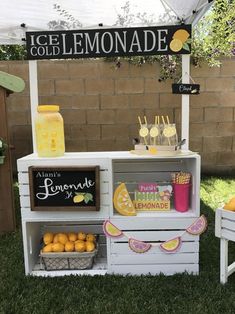 a lemonade stand is set up in the grass