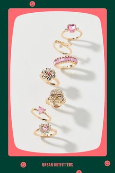 Set of seven rings in polished gold-tone metal finished with pink gems. Wear them together in a ring stack or mix and match your faves. Features Pink gem gold ring set Set of seven gold-tone rings Inset with pink rhinestones Includes heart rings, a skull ring and more Stack them together or mix and match Content + Care Set of 7 Mixed metal, glass Avoid contact with water Imported | Pink Gem Gold Ring Set in Gold, Women's at Urban Outfitters Pink Gem Ring, Pink Gem, Chunky Jewelry, Gem Ring, Brand Sale, Wellness Gifts, Mixed Metals, Women Accessories Jewelry, Gold Tone Metal