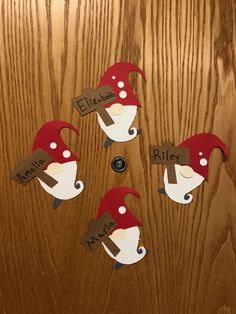 four pieces of paper cut out to look like gnomes with name tags on them