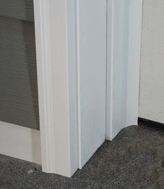 an open white door with the bottom half painted white and the bottom half in grey