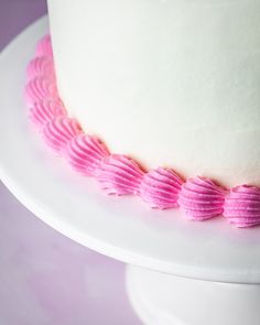 a white cake with pink ruffles on it