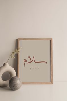 an arabic calligraphy is displayed next to a vase