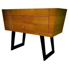 a wooden dresser sitting on top of a black metal frame