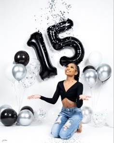 a woman sitting in front of balloons and numbers