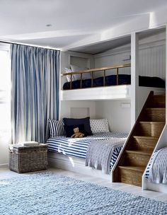 a bedroom with bunk beds and blue curtains