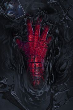 a red spider - man mask floating in the water next to a black frame with a photo on it