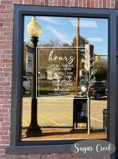 a sign is reflected in the window of a store