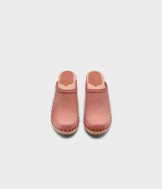 Made by skilled artisans in Sweden, these blush pink nubuck clog mules feature a high heel and eye-catching stud detailing on the sides. From date nights to ladies' nights out, Rome delivers unparalleled style and confidence. Clog measurements:Heel height: 2 5/8” (6.5 cm)Toe height:﻿ 1 1/2″ (3.8 cm) Fit:NarrowLeather:Nubuck leatherClogs consist of:Base: European Lime Wood Sole: Rubber sole Fastening: Brass studs Spring Slip-on Clogs With Studded Rubber Outsoles, Pink Rubber Sole Clogs For Spring, Pink Slip-on Clogs With Removable Insole, Pink Spring Clogs With Rubber Sole, Spring High Heel Clogs With Studded Rubber Outsoles, Summer Clogs With Contrasting Heel Counter And Round Toe, Spring Clogs With Contrasting Heel And Round Toe, Spring Clogs With Contrasting Heel Counter And Round Toe, Pink Spring Mules With Rubber Sole