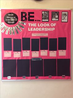 a pink and black bulletin board hanging on the wall next to a clock that reads be the look of leadership