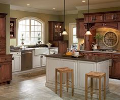 a large kitchen with wooden cabinets and an island