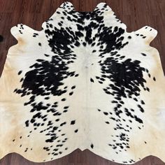 a cowhide rug with black spots on it