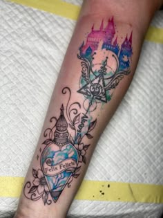 a person with a tattoo on their arm that has a castle and heart in it