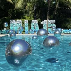 an inflatable pool with blue balls and the word miami spelled out behind it