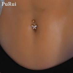 an image of a woman's stomach with a gold butterfly piercing on it and the words puru written below