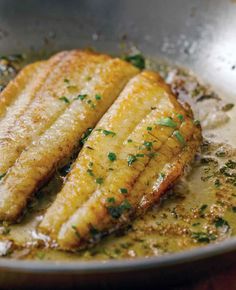 two pieces of fish are in a pan