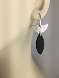 "The half circle for this earring is offered in 2 different finishes: 1) Antique Silver Alloy over Brass 2) 24 K Gold over Brass Extended from the half circles is black sea glass which is a nice contrast to either silver or gold. All metals used are lead safe. The ear wires are plated with a silver alloy and come with rubber back stoppers. The full length of the earrings including the post is 2 1/4\"." Sea Glass Earrings, Earrings Geometric, Half Circle, Black Earrings, Earrings Black, Black Sea, Geometric Earrings, Circle Earrings, Glass Earrings