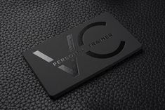 a black and silver business card with the words personal trainer on it's side