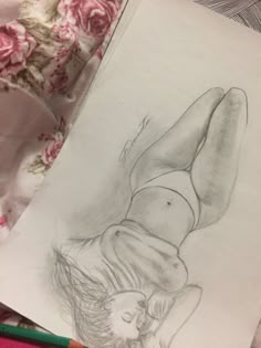 a pencil drawing of a woman laying on her back