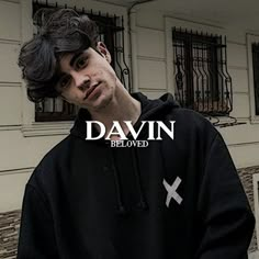 a young man standing in front of a building with the words davin below him