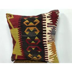 a decorative pillow made with multicolored kilims and geometrical shapes on a white background